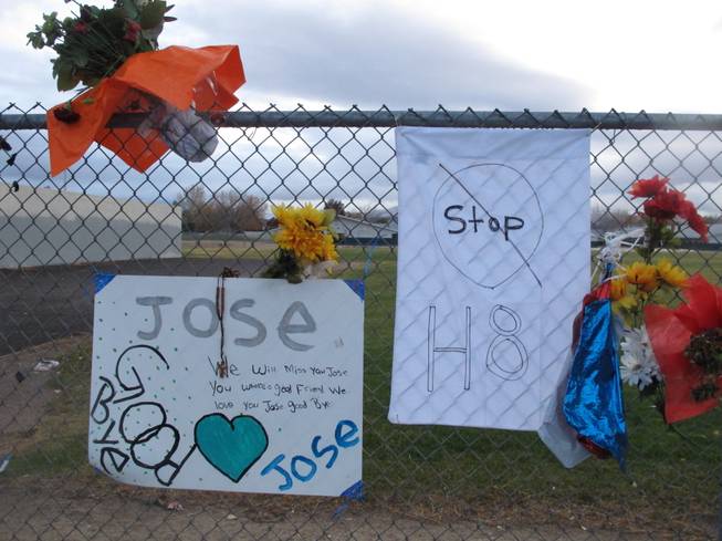 Friends have added a message to Jose Reyes and a small wooden cross at a memorial pictured Monday, Oct. 28, 2013, outside Sparks Middle School, where the seventh-grader fatally shot a teacher and wounded two 12-year-old classmates before killing himself in the school yard a week ago. Students returned to classes Monday for the first time since the Oct. 21 shooting.