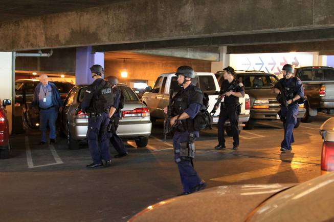 SWAT officers search a parking garage during a security check at the Los Angeles International Airport on Friday Nov. 1, 2013. Shots were fired Friday at Los Angeles International Airport, prompting authorities to evacuate a terminal and stop flights headed for the city from taking off from other airports.