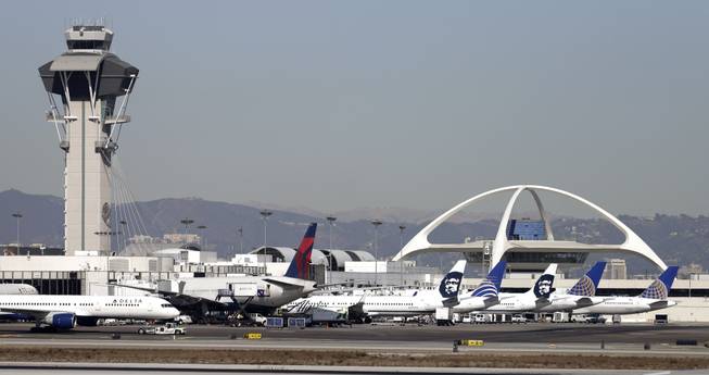 Airplanes sit on the tarmac at Los Angeles International Airport Friday, Nov. 1, 2013. Thousands of fliers were delayed Friday after a shooting in Terminal 3 closed parts of the airport for hours, prompting authorities to evacuate a terminal and stop flights headed for the city from taking off from other airports. Los Angeles police said a suspected gunman has been taken into custody.