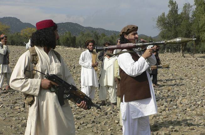 In this Sunday, Oct. 4, 2009, file photo, Pakistani Taliban chief Hakimullah Mehsud, right, holds a rocket launcher with his comrades in Sararogha of Pakistani tribal area of South Waziristan along the Afghanistan border. Intelligence officials said Friday, Nov. 1, 2013, that Mehsud was one of three people killed in a U.S. drone strike.