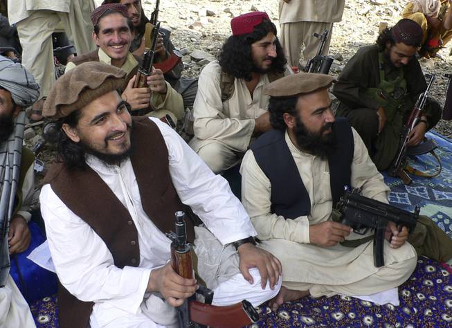In this file photo taken Sunday, Oct. 4, 2009, Pakistani Taliban chief Hakimullah Mehsud, left, is seen with his comrade Waliur Rehman, front center, during his meeting with media in Sararogha in the Pakistani tribal area of South Waziristan along the Afghanistan border. Intelligence officials said Friday, Nov. 1, 2013, that Mehsud was one of three people killed in a U.S. drone strike.