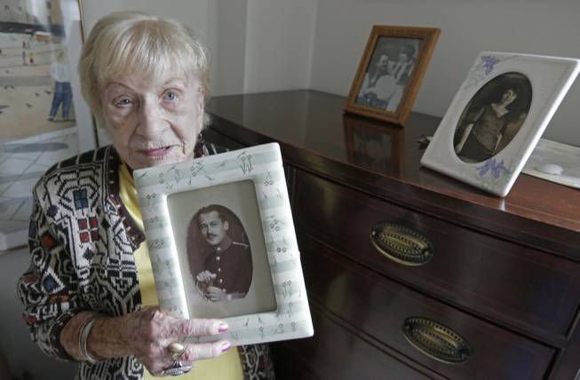 FILE - In this July 30, 2013 file photo, Holocaust survivor 92-year-old Edith Stern holds a picture of her father at the retirement community called Selfhelp Home, on the North Side of Chicago. Though pregnant, she miraculously avoided the gas chamber at Auschwitz. She lost her mother, father and husband in the camps. After liberation, she faced even more heartbreak: Her son died days after his birth. (AP Photo/M. Spencer Green, File)