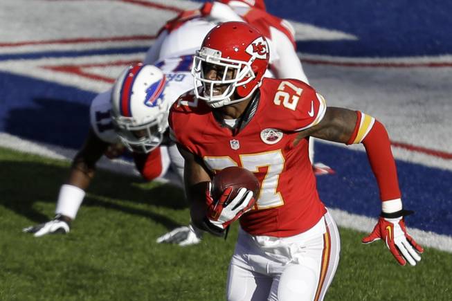 Kansas City Chiefs cornerback Sean Smith intercepts a pass intended for Buffalo Bills wide receiver T.J. Graham (11), who is tackled by Kansas City Chiefs cornerback Marcus Cooper (31) in the end zone, and returns it for a touchdown during the third quarter of an NFL football game in Orchard Park, N.Y., Sunday, Nov. 3, 2013.