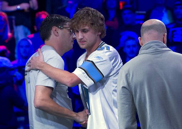 Mark Newhouse, left, 28, of Los Angeles shakes hands with Ryan Riess, 23, of Las Vegas after Riess knocked him out of the final table of the World Series of Poker $10,000 buy-in, no-limit Texas Hold 'Em tournament at the Rio on Monday, Nov. 4, 2013.