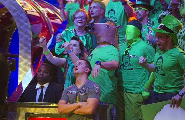 Family and friends of Marc-Etienne McLaughlin, 25, a poker player from Brossard, Quebec, Canada, celebrate as McLaughlin, below center, survives going all-in against J.C.Tran during the final table of the World Series of Poker $10,000 buy-in no-limit Texas Hold 'Em tournament at the Rio Monday, Nov. 4, 2013.
