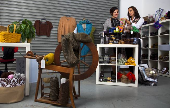 Brenda Johannessen (right) with Unwind Knitting located Inside the Stitch Factory talks with Jen Taler Tuesday about the various yarns which van be selected to knit great scarves. The shop offers a selective supply of luxury yarns and classes for knitting and crocheting. Nov. 5, 2013. L.E. Baskow