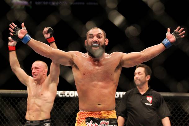 Johny Hendricks and Georges St. Pierre raise their arms after the end of their title fight at UFC 167 Saturday, Nov. 16, 2013 at the MGM Grand Garden Arena. St. Pierre retained his belt in a controversial split decision.
