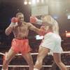 Photo: Evander Holyfield, left, lands a punch to body of Photo: Evander Holyfield, left, lands a punch to body of