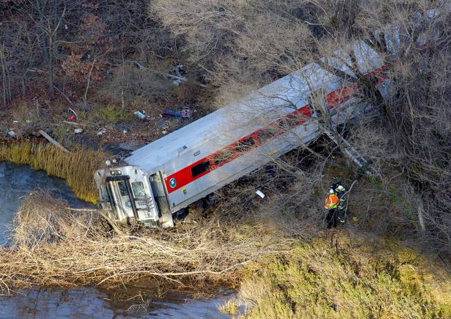 First responders view the derailment of a Metro North passenger train in the Bronx borough of New York Dec. 1, 2013. The Fire Department of New York says there are "multiple injuries" in the train derailment, and 130 firefighters are on the scene. Metropolitan Transportation Authority police say the train derailed near the Spuyten Duyvil station.
