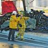 Photo: Sheriff's deputies work near the wreckage of a Por Photo: Sheriff's deputies work near the wreckage of a Por