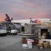 Photo: Brenda Thompson, right, loads packages into a cont Photo: Brenda Thompson, right, loads packages into a cont