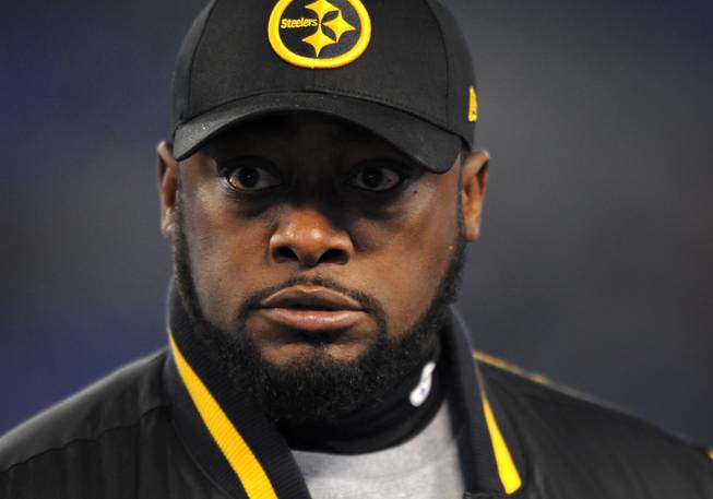 In this Nov. 28, 2013, file photo, Pittsburgh Steelers head coach Mike Tomlin watches his players warm up before an NFL football game against the Baltimore Ravens, in Baltimore. Tomlin says he's embarrassed about his unintentional but inexcusable foray onto the field in last Thursday night's loss to Baltimore.