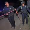 Photo: Police agents cordon off an area in the village of Photo: Police agents cordon off an area in the village of