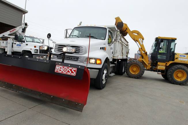 A sand spreader truck is loaded with sand mix for upcoming cold winter storm at the North Texas Tollway Authority's maintenance center in Plano, Texas, on Thursday, Dec. 5, 2013. A winter weather storm is heading into the area, with below-freezing temperatures and precipitation beginning to fall in North Texas. Predictions call for possibilities of sleet or freezing rain and icy road conditions.