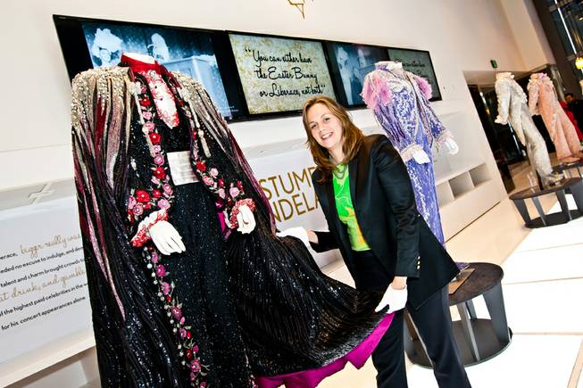 Curator Deirdre Clemente, PhD, shows the intricate designs of Liberace's rhinestone Purple and Pink Phoenix jumpsuit while giving a walk-through of the Liberace Exhibition at the Cosmopolitan in Las Vegas Deceber 6, 2013. Clemente is assistant professor of history and associate director of the public history program at the University of Nevada, Las Vegas. She also served as historical consultant for Buz Luhrmanns The Great Gatsby.
