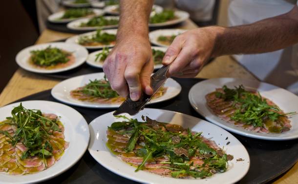 Carpaccio is topped with fresh truffles to be served next at La Cucina's Grand Banquet at the Venetian on Friday Dec. 6, 2013.