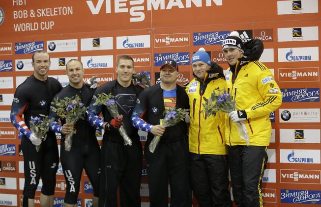 From left to right, second finishers Dallas Robinson and Nick Cunningham from the United States; first place finishers Christopher Fogt and Steven Holcomb, from the United States and third place finishers Francesco Friedrich and Jannis Baecker pose for a photo following the men's World Cup two-man bobsled competition Friday, Dec. 6, 2013, in Park City, Utah.