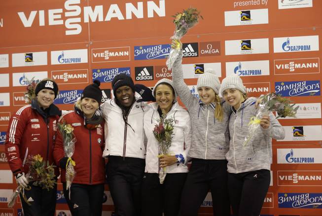 From left to right, second place finishers Kaillie Humphries and Heather Moyse of Canada, first place finishers Aja Evans and Elana Meyers of the United States and third place finishers Jamie Greubel and Katie Eberling of the United States pose for a photo following the women's World Cup two-man bobsled competition Friday, Dec. 6, 2013, in Park City, Utah.