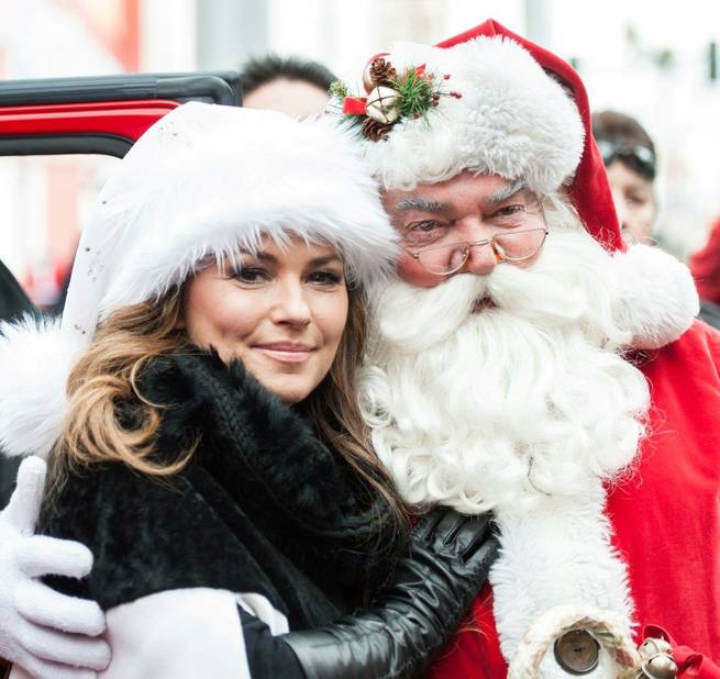Grand marshal and Caesars Palace headliner Shania Twain and Santa Claus attend the 2013 Great Santa Run on Saturday, Dec. 7, 2013, in downtown Las Vegas.