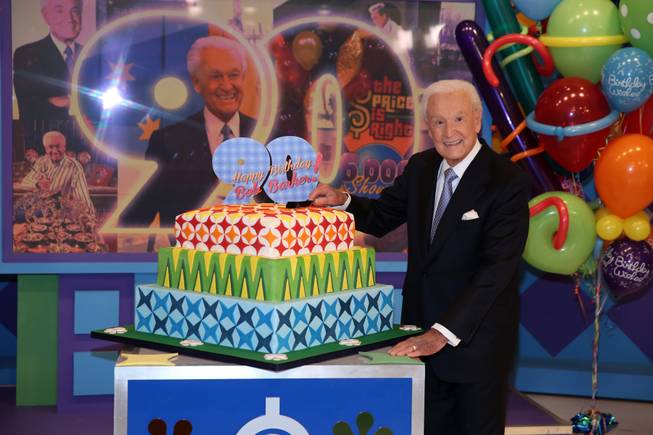 This Nov. 5, 2013, photo shows Bob Barker posing on the set of "The Price Is Right" with a cake celebrating his 90th birthday at CBS Studios in Los Angeles. The veteran game show host, at the helm of “The Price Is Right” from 1972 to 2007, was invited back by current host Drew Carey on Thursday, Dec. 12, to celebrate the milestone birthday.