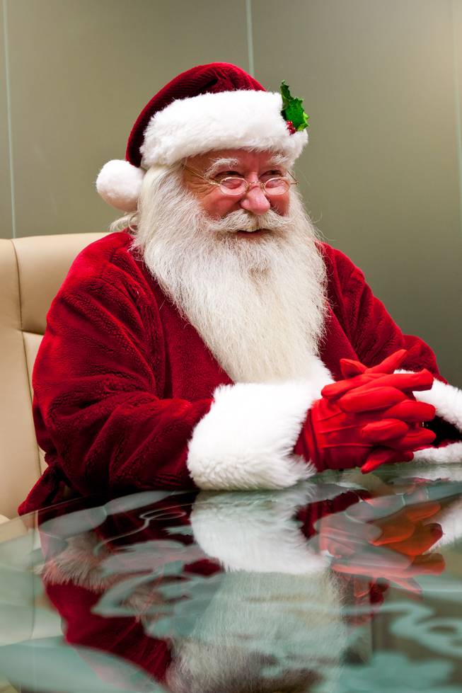 Santa Claus shares his most cherished "Santa" memories while sitting in the offices at Tivoli Village prior to visiting with the children in his cottage in Las Vegas Friday, December 13, 2013. Larry Hansen has been donning the coveted suit and sharing the spirit of Santa for over nine years in Las Vegas.