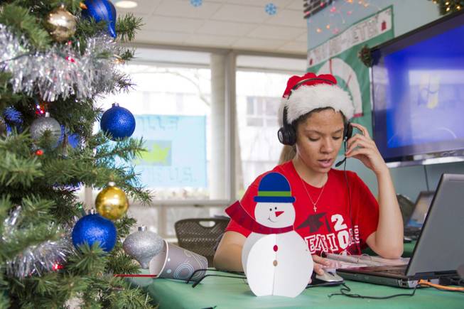 Katherine Moss, a student and Snyder Hall resident at the University of Illinois, sings to callers as part of the hall's annual Dial-A-Carol program in Champaign, Ill. The student-run project is a hotline of sorts for people who prefer their holiday carols sung live by amateurs. The program was started in 1960 by a former hall secretary, Betty Gordon, and a group of the dorm’s residents. Last year, the student volunteers took more than 4,000 calls from people all over the world requesting “Jingle Bells,” “White Christmas” and “Rudolph the Red-Nosed Reindeer.”