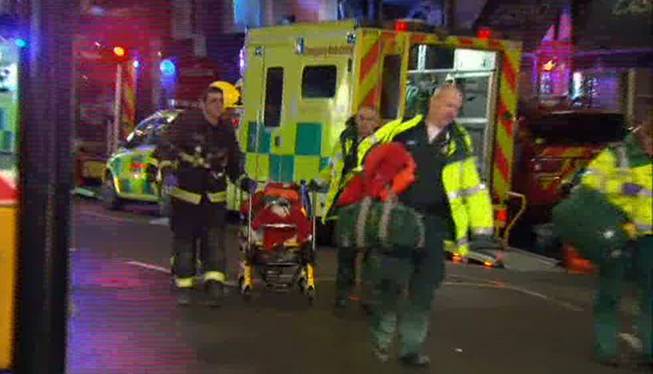 This image taken from television shows emergency services evacuating a person on a stretcher following an incident at the Apollo Theatre, in London's Shaftesbury Avenue, Thursday evening, Dec. 19, 2013, during a performance at the height of the Christmas season, with police saying there were "a number" of casualties.