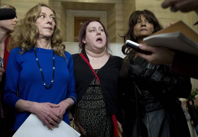 From left, Valerie Scott, Amy Lebovitch and Terri-Jean Bedford talks to reporters at the Supreme Court of Canada in Ottawa Friday morning, Dec. 20, 2013, after learning Canada's highest court struck down the country's prostitution laws in their entirety in a unanimous 9-0 ruling. Scott, a former prostitute; Bedford, a retired dominatrix, and Lebovitch, a sex worker, are the three principals in the case.