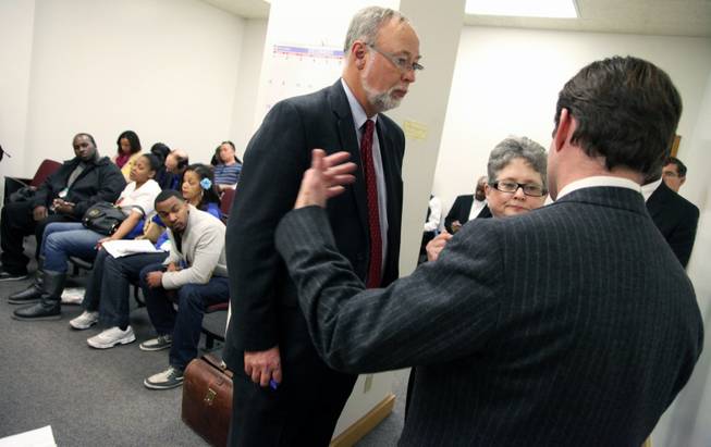 From left, Douglas Straus, attorney for Children's Hospital, speaks to Jacquelyn Garman, vice [resident and general counsel for Children's Hospital, and Christopher Dolan, attorney for the family of Jahi McMath, during a hearing in Department 31 in the Post Office Building, Friday, Dec. 20, 2013 in Oakland, Calif. A judge on Friday ordered a California hospital to keep a girl declared brain dead on life support following what was supposed to be a routine tonsillectomy.