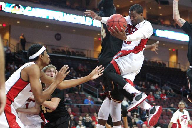 UNLV guard Deville Smith tries to dish off the ball to forward Chris Wood during their Continental Tire Las Vegas Classic game against Santa Clara Sunday, Dec. 2013, at the Orleans Arena. UNLV won 92-71 and will face Mississippi State in the championship game Monday night.
