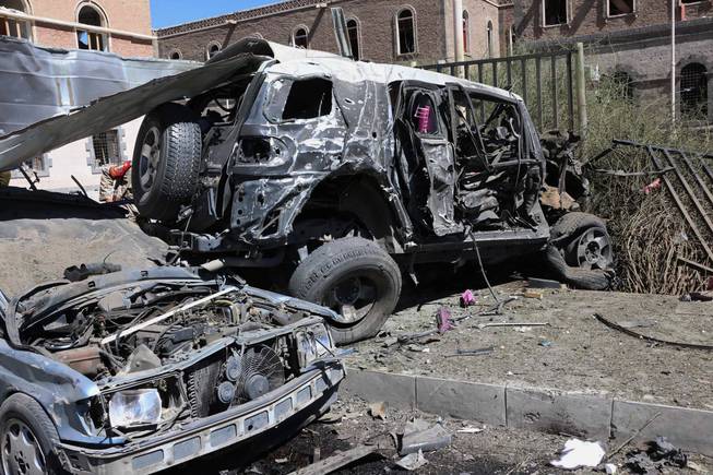 This Thursday, Dec. 5, 2013, file photo provided by Yemen's Defense Ministry shows damaged vehicles after an explosion at the Defense Ministry complex in Sanaa, Yemen. The militant leader of al-Qaida's branch in Yemen said in a video posted on militant websites late Saturday, Dec. 21, that its fighters attacked a hospital and a place for prayer at the complex that they had been warned not to attack.