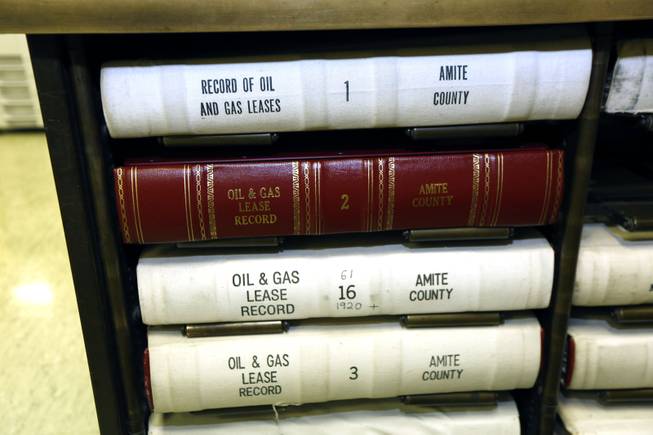 In this Dec. 23, 2013 photograph, Amite County land and mineral property records and oil and gas leases at the county courthouse in Liberty, Miss., are among the records researched by leasing agents that have flocked to the county's antebellum courthouse in Liberty, Miss. The agents review a variety of records to determine land and mineral rights to property that might be on or along the Tuscaloosa Marine Shale formation that may hold billions of barrels of oil.