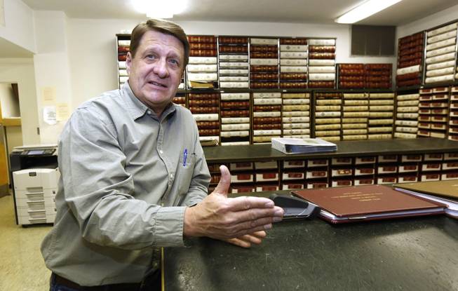 In this Dec. 23, 2013 photograph, Amite County Chancery Clerk Ronnie Taylor talks about the large number of leasing agents that have flocked to the county's antebellum courthouse in Liberty, Miss. The agents review a variety of records to determine land and mineral rights to property that might be on or along the Tuscaloosa Marine Shale formation that may hold billions of barrels of oil.