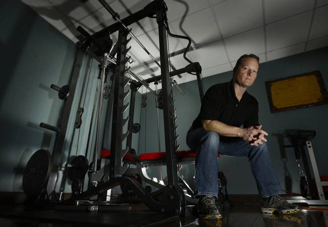 Dr. Jason Cabler sits in the exercise room of his home in Hendersonville, Tenn. Cabler, 46, suffered a heart attack on Christmas Day in 2012 while lifting weights in the basement gym. Studies indicate that heart troubles, including fatal heart attacks, spike this time of year, especially on Christmas and New Year's.