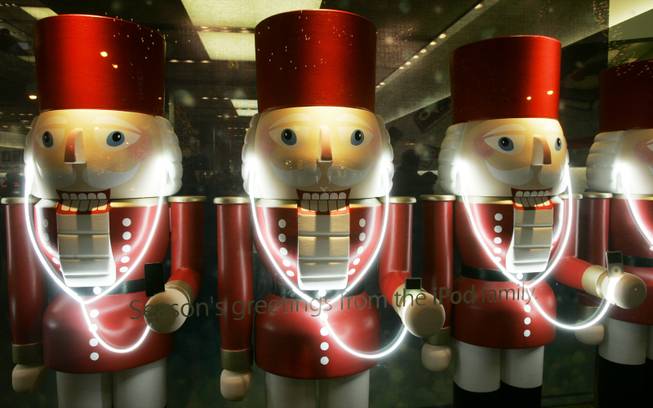 In this Thursday, Nov. 29, 2007, file photo, a display of three nutcracker soldiers wear iPods at the Apple Store on Chicago's Magnificent Mile. Americans spent several years stocking up on smartphones, tablet computers and ever-bigger size TVs. But in 2013's holiday season, they’re buying headphones, wireless speakers and other accessories to go with them.