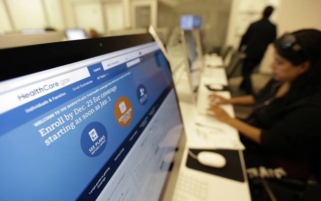 Rosemary Cabelo uses a computer at a public library to access the Affordable Health Care Act website in San Antonio. Health care workers and officials in Texas on Monday, Dec. 23, 2013, rushed to sign people up for insurance plans, even after receiving a one-day extension on a deadline for customers buying coverage under the new federal health care law to have their plans kick in Jan. 1.