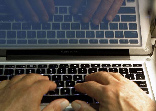 In this Wednesday, Feb. 27, 2013, photo illustration, hands type on a computer keyboard in Los Angeles. Companies including Google and the Huffington Post are trying everything from deploying moderators to forcing people to use their real names in order to restore civil discourse on online comment threads.