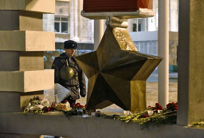 A soldier guards the Volgograd main railway station in Volgograd, Russia early Monday, Dec. 30, 2013. A bomb blast tore through a trolleybus in the city of Volgograd on Monday morning, killing at least 10 people a day after a suicide bombing that killed at least 17 at the city's main railway station.