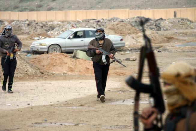 Gunmen patrol after clashes with Iraqi security forces in Fallujah, 40 miles west of Baghdad on Sunday, Jan. 5, 2014. Lt. Gen. Rasheed Fleih, who leads the Anbar Military Command, told the state television Sunday that "two to three days" are needed to push the militants out of Fallujah and parts of Ramadi.