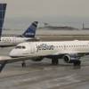 Photo: A JetBlue airplane taxis to park at a gate at Loga Photo: A JetBlue airplane taxis to park at a gate at Loga