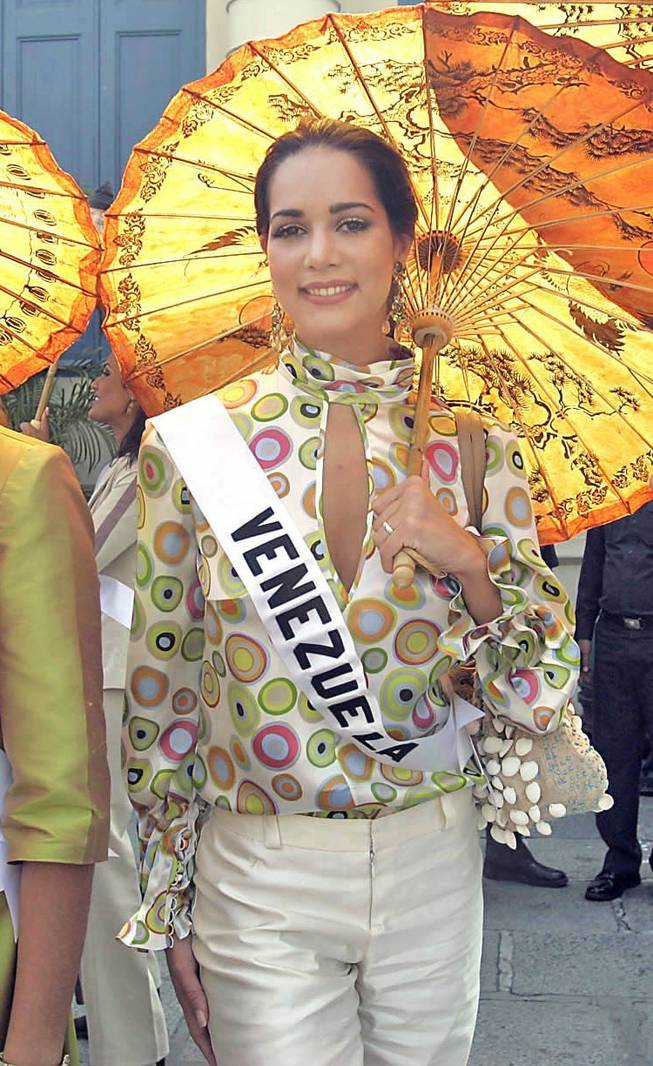 In this May 11, 2005, file photo, Miss Venezuela Monica Spear poses for photographs outside the Grand Palace ahead of the Miss Universe Pageant in Bangkok, Thailand. Venezuelan authorities say the soap-opera actress and former Miss Venezuela and her ex-husband were shot and killed resisting a robbery after their car broke down. Prosecutors said in a statement that Monica Spear and Henry Thomas Berry were slain late Monday, Jan. 6, 2014, near Puerto Cabello, Venezuela’s main port.