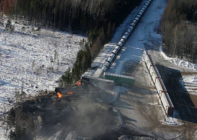 This aerial photo shows derailed train cars burning in Plaster Rock, New Brunswick on Wednesday, Jan. 8, 2014. A Canadian National Railway freight train carrying crude oil and propane derailed Tuesday night in a sparsely populated region of northwestern New Brunswick. More than 100 residents remained evacuated from their homes. There were no deaths or injuries.