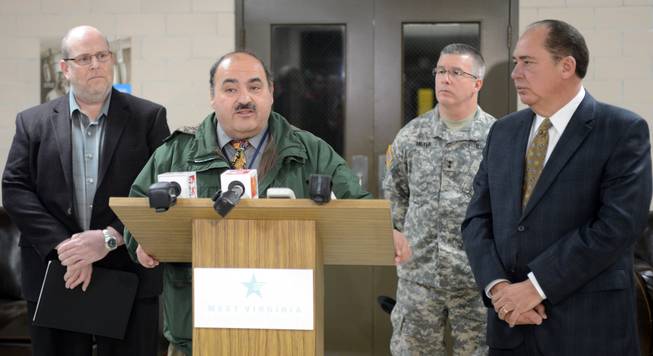 Jimmy Gianato, the director of the West Virginia Department of Homeland Security, at podium, addresses reporters during a press conference about the regional water contamination late Thursday, Jan. 9, 2014. in Charleston, W.Va. With him are West Virginia American Water President Jeff McIntyre,left, West Virginia National Guard Adj. Gen. James Hoyer and Governor Earl Ray Tomblin, right.