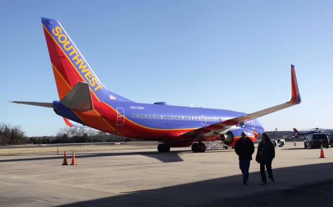 Southwest Airlines Flight 4013 sits at the M. Graham Clark Downtown Airport in Hollister, Mo., Monday, Jan. 13, 2014. The plane was supposed to land at the nearby Branson Airport on Sunday evening, but instead landed at Clark Airport, also known as Taney County Airport, which has a much shorter runway than at Branson, about 7 miles away.