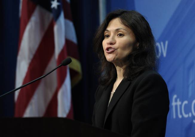 Federal Trade Commission Chair Edith Ramirez speaks at the FTC in Washington, Wednesday, Jan. 15, 2014, where she announced Apple will refund $32.5 million to consumers to settle a federal case involving purchases that kids made without their parents' permission while playing on mobile apps.