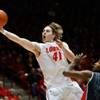 New Mexico's Cameron Bairstow scores under the basket in front of UNLV's Roscoe Smith in the first half of an NCAA college basketball game on Wednesday, Jan. 15, 2014, in Albuquerque. New Mexico's Cameron Bairstow scores under the basket in front of UNLV's Roscoe Smith in the first half of an NCAA college basketball game on Wednesday, Jan. 15, 2014, in Albuquerque.