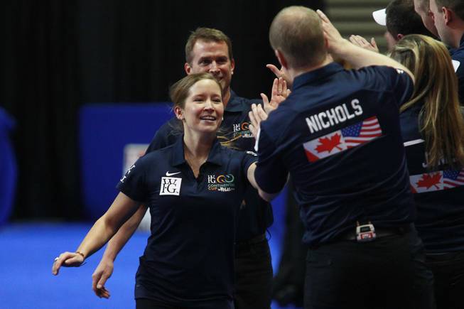 Jennifer Jones is congratulated after winning mixed doubles match during the first day of the 2014 World Financial Group Continental Cup of Curling at the Orleans Arena Thursday, Jan. 16, 2014. Of the twelve teams competing from around the world, nine of them will represent their respective country at the upcoming Olympics in Sochi, Russia.
