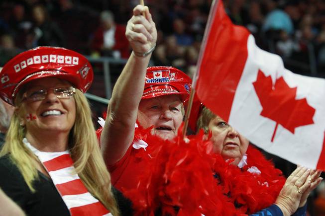 From left, Barb McKee, Wava Brown and Shirley Challice, all from Peterborough, Ontario, cheer during the first day of the 2014 World Financial Group Continental Cup of Curling at the Orleans Arena Thursday, Jan. 16, 2014. Of the twelve teams competing from around the world, nine of them will represent their respective country at the upcoming Olympics in Sochi, Russia.