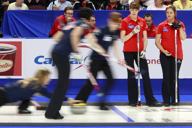 Anna Sloan, right, and Claire Hamilton watch as their competition sends a stone down the curling sheet during the first day of the 2014 World Financial Group Continental Cup of Curling at the Orleans Arena Thursday, Jan. 16, 2014. Of the twelve teams competing from around the world, nine of them will represent their respective country at the upcoming Olympics in Sochi, Russia.