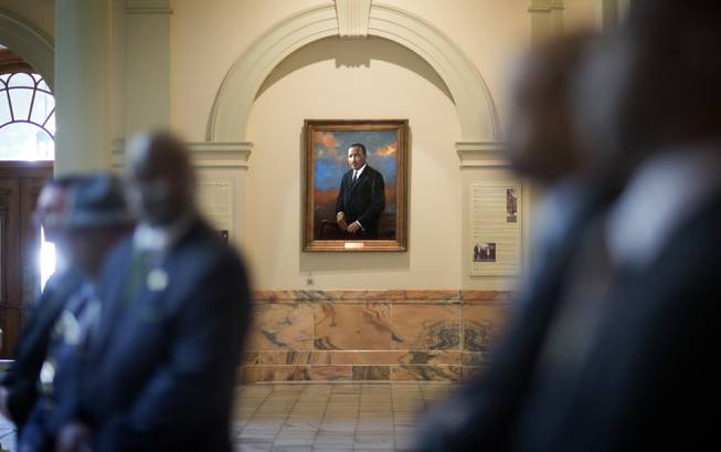 A portrait of Rev. Martin Luther King, Jr., hangs in the hallway of the State Capitol during a ceremony paying tribute to King Jr., Friday, Jan. 17, 2014, in Atlanta. The national Dr. Martin Luther King Jr. federal holiday this year is Monday, Jan. 20, five days after the civil rights leader would have turned 85-years-old.